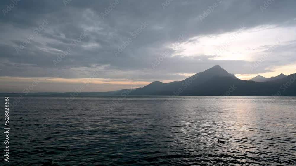 Captivating sunset creating beautiful scene on Lake Garda, Italy. Tripod shot. Captivating sunset creating beautiful scene on Lake Garda, Italy. Tripod shot.