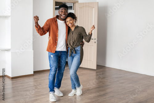 Joyful Black Couple Gesturing Yes Celebrating Moving To New Home © Prostock-studio