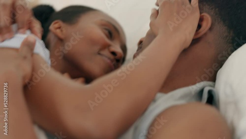 Love, kiss and bedroom intimacy with black couple being playful and affectionate while laughing and touching at home. Happy man and woman relax, resting and bonding for healthy relationship