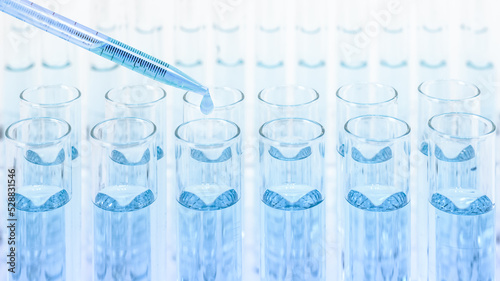 test tubes with dropper drop some blue liquid in laboratory