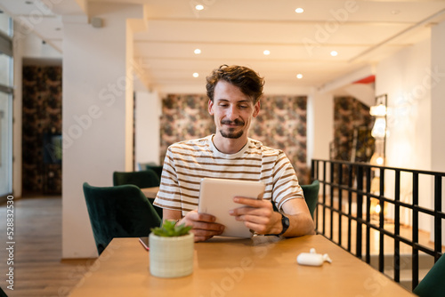 one caucasian man young adult millennial male using digital tablet