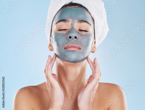 Skincare, beauty and face mask on a woman while doing her wellness routine in a studio. Latina girl with fresh, body care and hygiene lifestyle doing selfcare facial treatment to relax after a shower