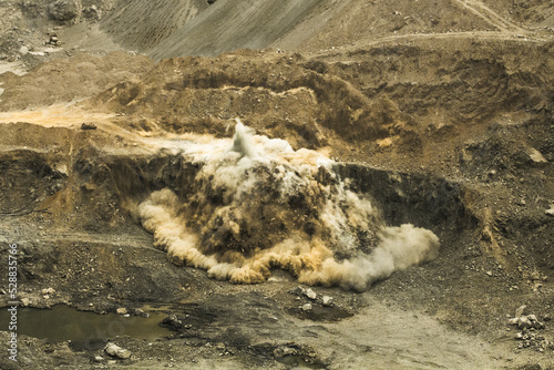 Blasting TNT explosion bomb rock in the open pit miner site