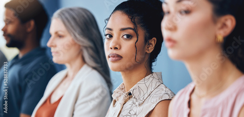 Training, learning and education with a business woman looking serious and sitting in a conference or workshop for coaching. Portrait of a female employee in an audience for a development seminar