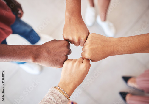 Hands, teamwork and collaboration with a team of business people joining their fists in a circle in solidarity, unity and support from above. Motivation, goal and a mission or vision for success