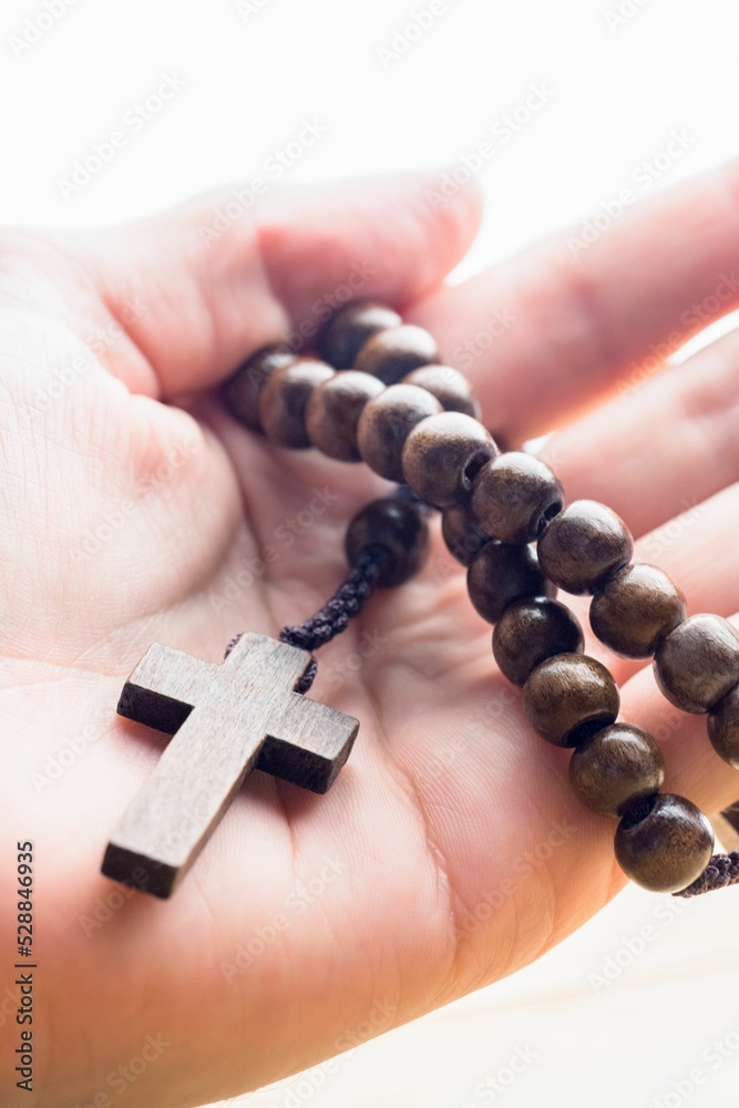 Fototapeta premium Hand holding rosary beads