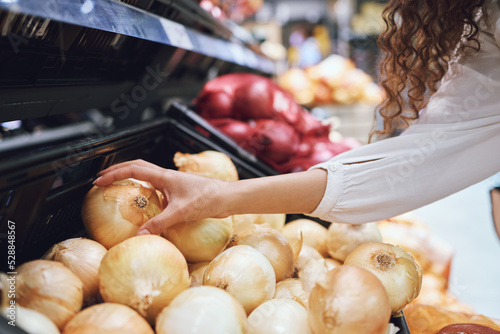 Tableau sur toile Vegetables, grocery shopping and health while a customer choose fresh onions in supermarket or greengrocer store