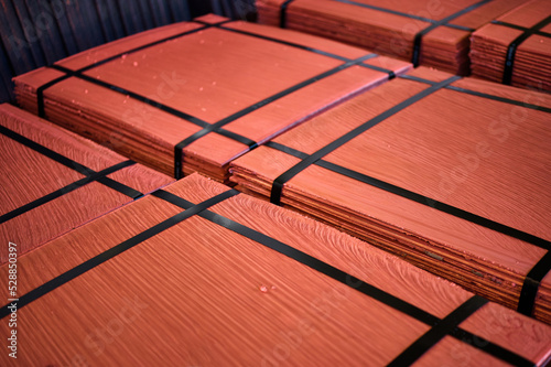 Piles of cathode copper plates at metal purification plant photo