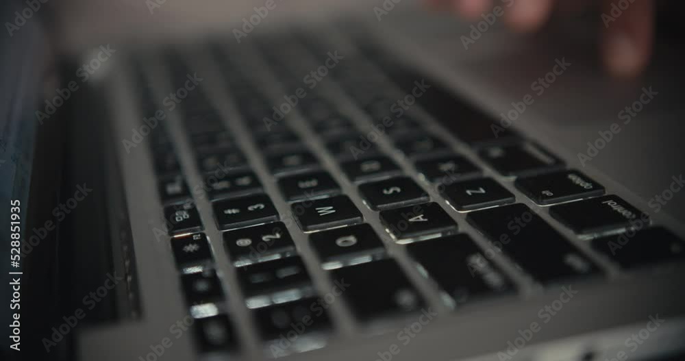 Cinematic close up of woman's hands typing on a laptop keyboard while working. Cinematic close up of woman's hands typing on a laptop keyboard while working.