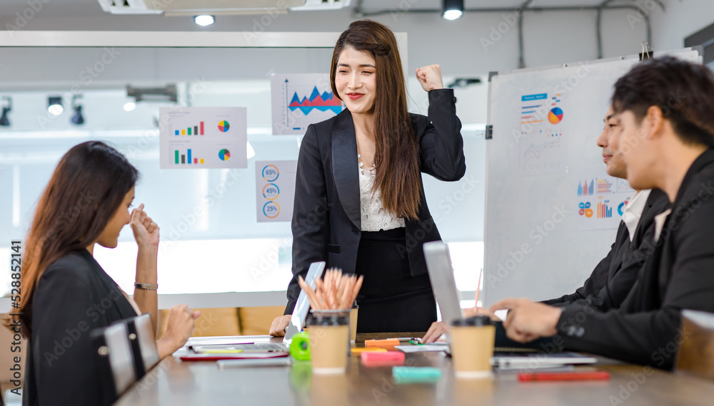 Asian young beautiful professional successful businesswoman presenter standing smiling in front of glass board after presenting while male female colleagues clapping hands thank you in meeting room Asian young beautiful professional successful businesswoman presenter standing smiling in front of glass board after presenting while male female colleagues clapping hands thank you in meeting room