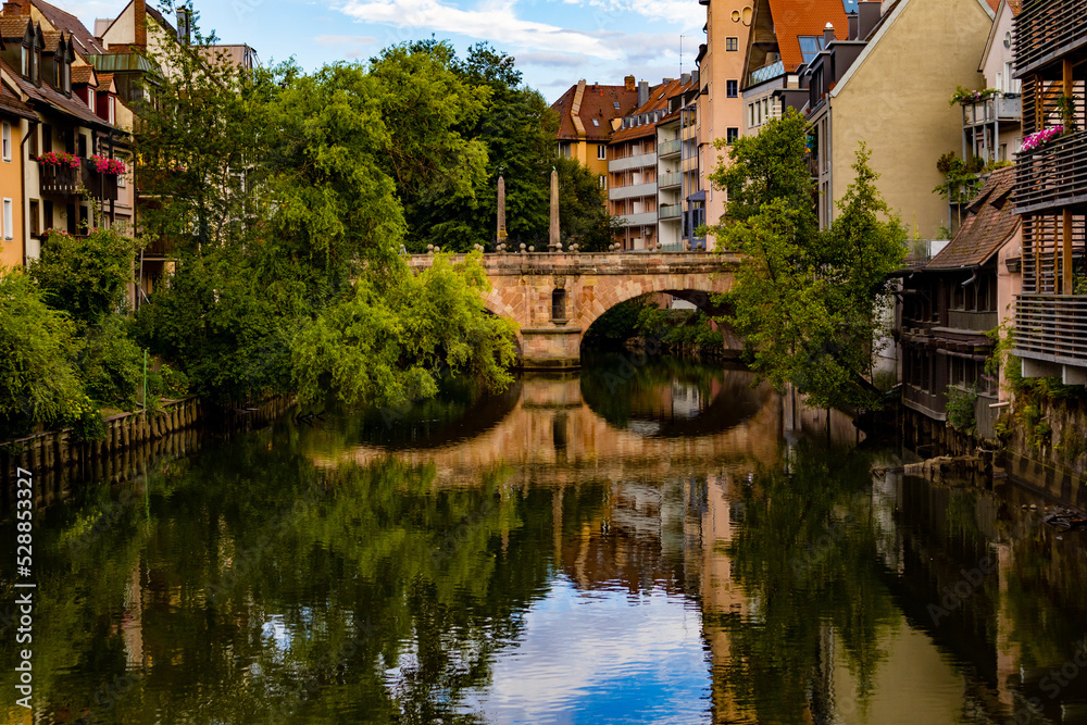 Fototapeta premium A bridge across the river between the houses