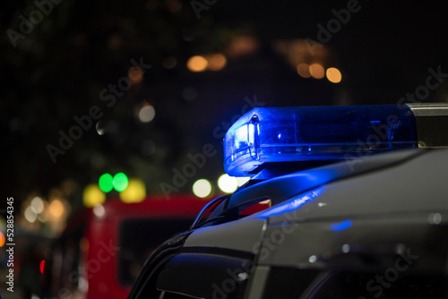 Emergency light of police patrolling car on street in night