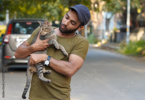Photography Indian man holding a cat