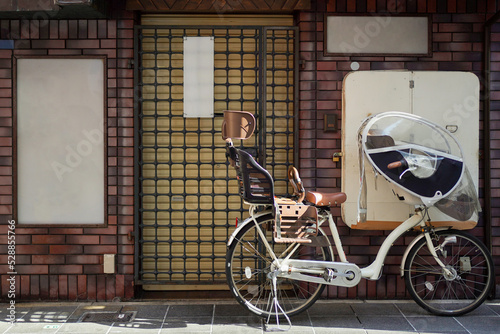 White bicycle park outside a random Japan concrete house