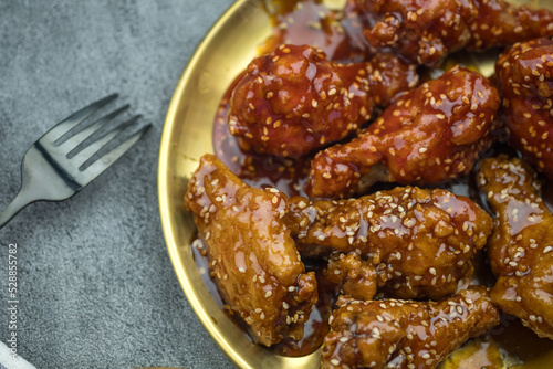 Deep fried chicken wings or barbecue sprinkled with white sesame. Spicy Korean style fried chicken, Korean food. Use for the menu in the restaurant.