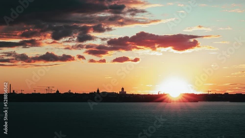 Time-lapse of sunset turning to dusk, clouds moving over the Helsinki skyline photo