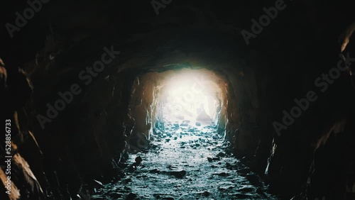 Shot in a cave like place traveling forward to a bright light where some indistinct peoples are waiting. Giving this interesting near death experience feeling. photo