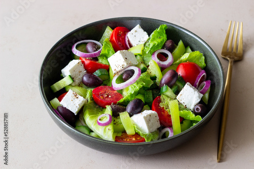 Greek salad with feta cheese  tomatoes  cucumbers  peppers and Kalamata olives. Healthy eating. Vegetarian food.