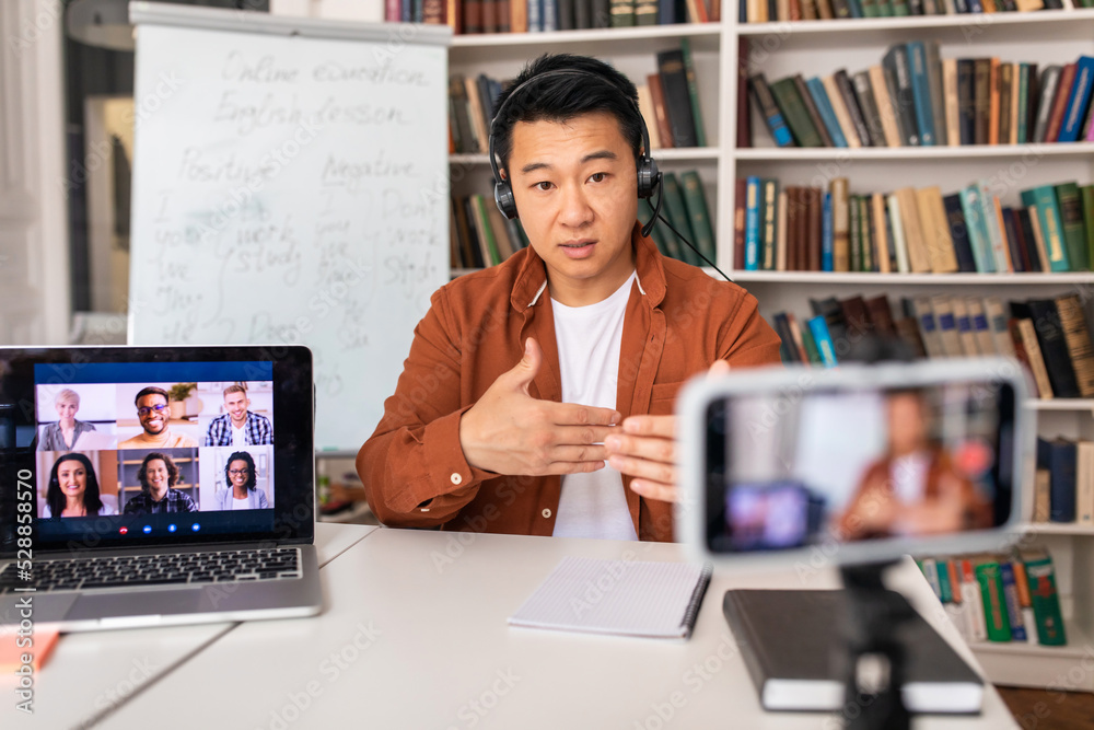 Asian Teacher Man Filming Lecture Teaching Online Sitting At Workplace Asian Teacher Man Filming Lecture Teaching Online Sitting At Workplace
