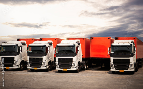 Semi TrailerTrucks Parked Lot with The Sunset Sky. Shipping Container. Delivery Transit. Engine Diesel Trucks. Lorry Tractor. Industry Freight Trucks Logistics Cargo Transport. photo