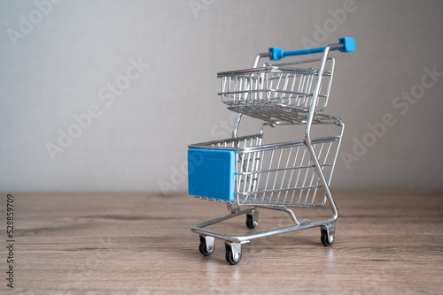 empty shopping cart, supermarket trolley, concept of saving money, reduced income, less spending, poverty, crisis  © Anna Ivanovska