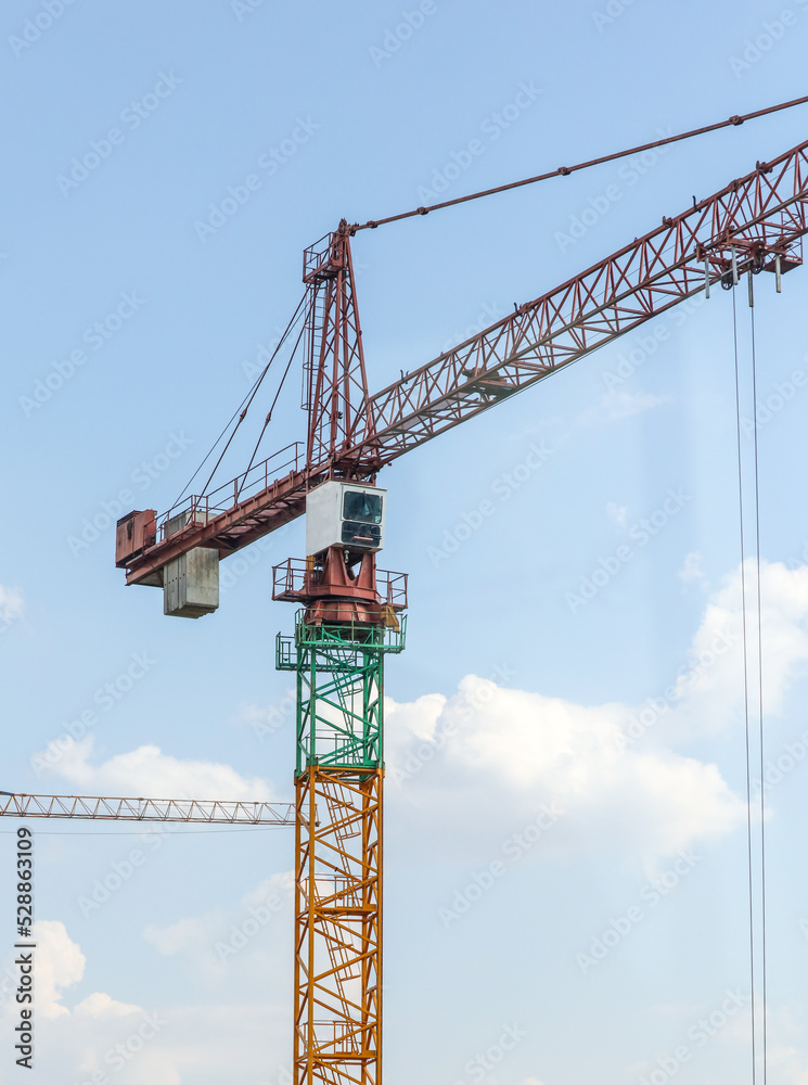Tower crane at the construction site of a multi-storey building.