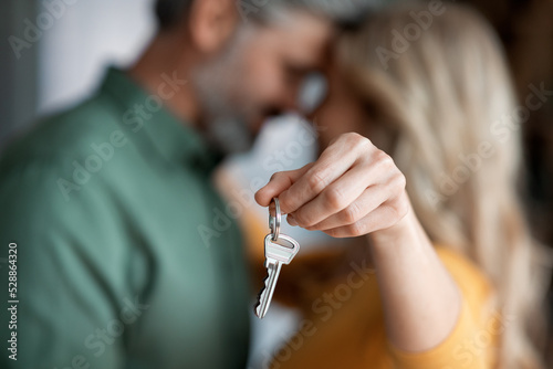 Closeup Shot Of Romantic Middle Aged Couple Holding Home Keys