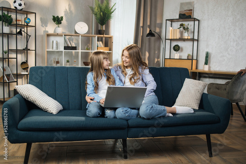 Photography Caucasian cute female children sitting on couch using laptop