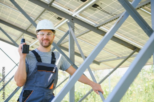 Worker installing solar panels outdoors