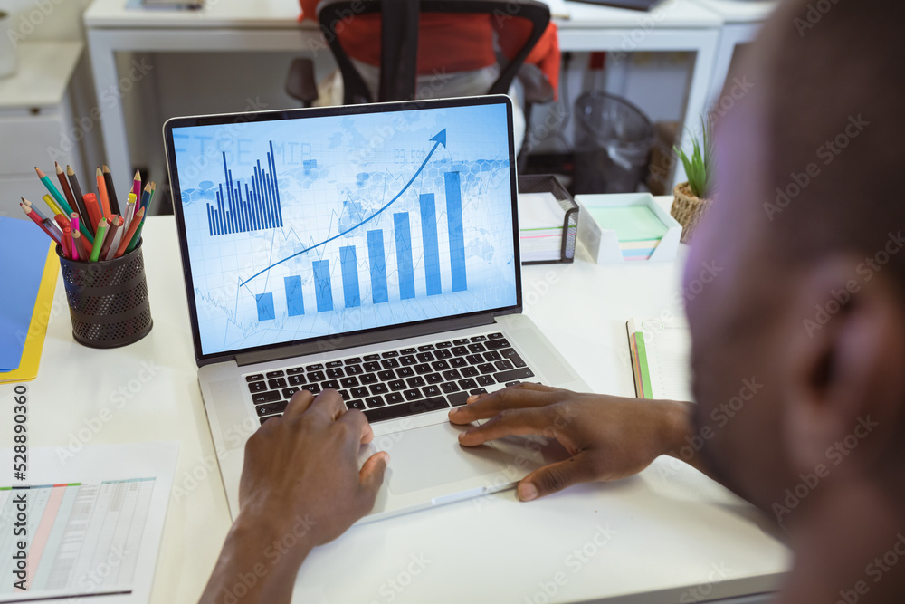 Composition of african american businessman using laptop with data processing Composition of african american businessman using laptop with data processing
