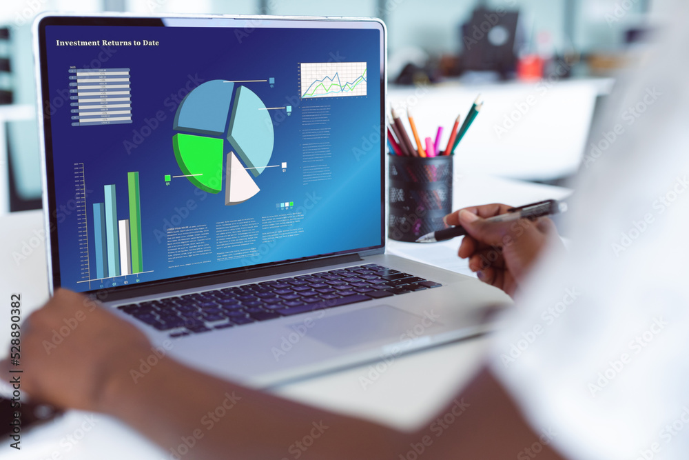 African american businesswoman using laptop with data processing African american businesswoman using laptop with data processing