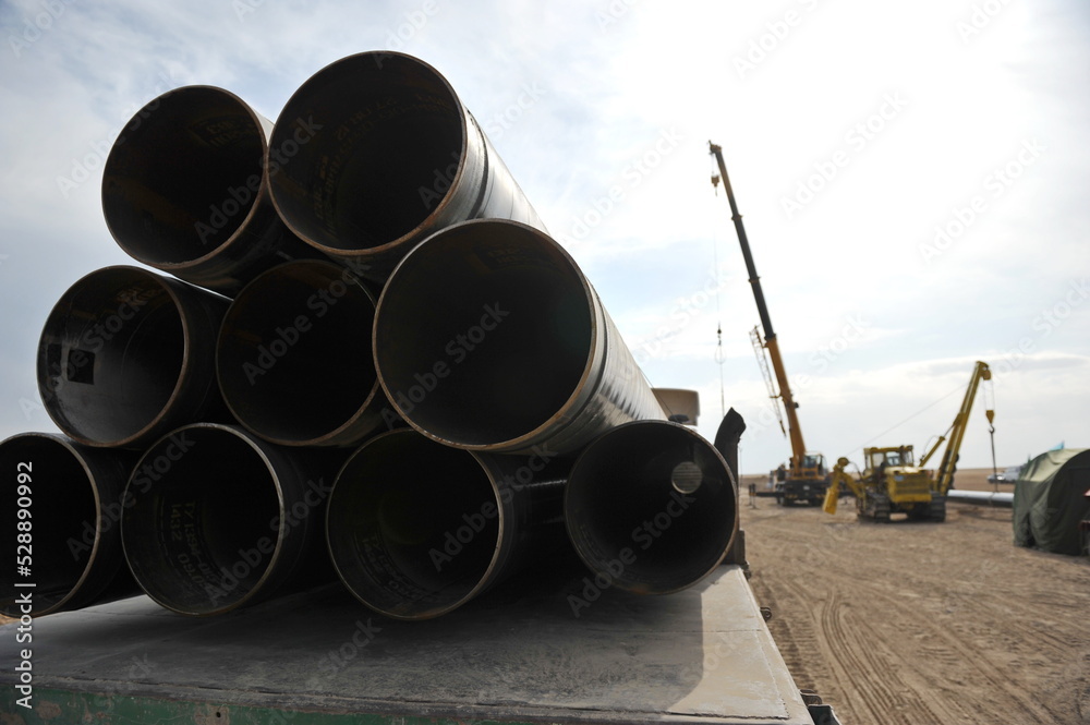 Almaty, Kazakhstan - 09.29.2012 : A bundle of pipes for a gas pipeline is stacked on a construction site Almaty, Kazakhstan - 09.29.2012 : A bundle of pipes for a gas pipeline is stacked on a construction site