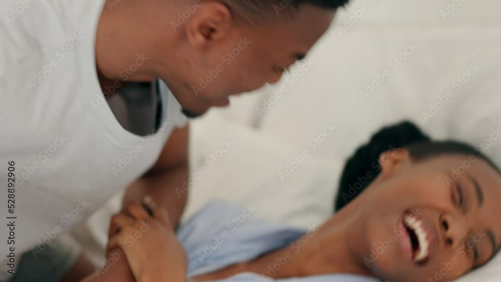 Happy black couple playing, laughing and love in the bedroom, joyful and playful at home. African man and woman in happiness with smile, joy and laughter on the bed in funny relationship together Happy black couple playing, laughing and love in the bedroom, joyful and playful at home. African man and woman in happiness with smile, joy and laughter on the bed in funny relationship together