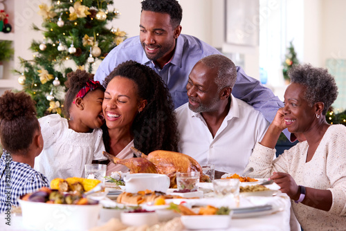 Multi-Generation Family Celebrating Christmas At Home Eating Meal Together