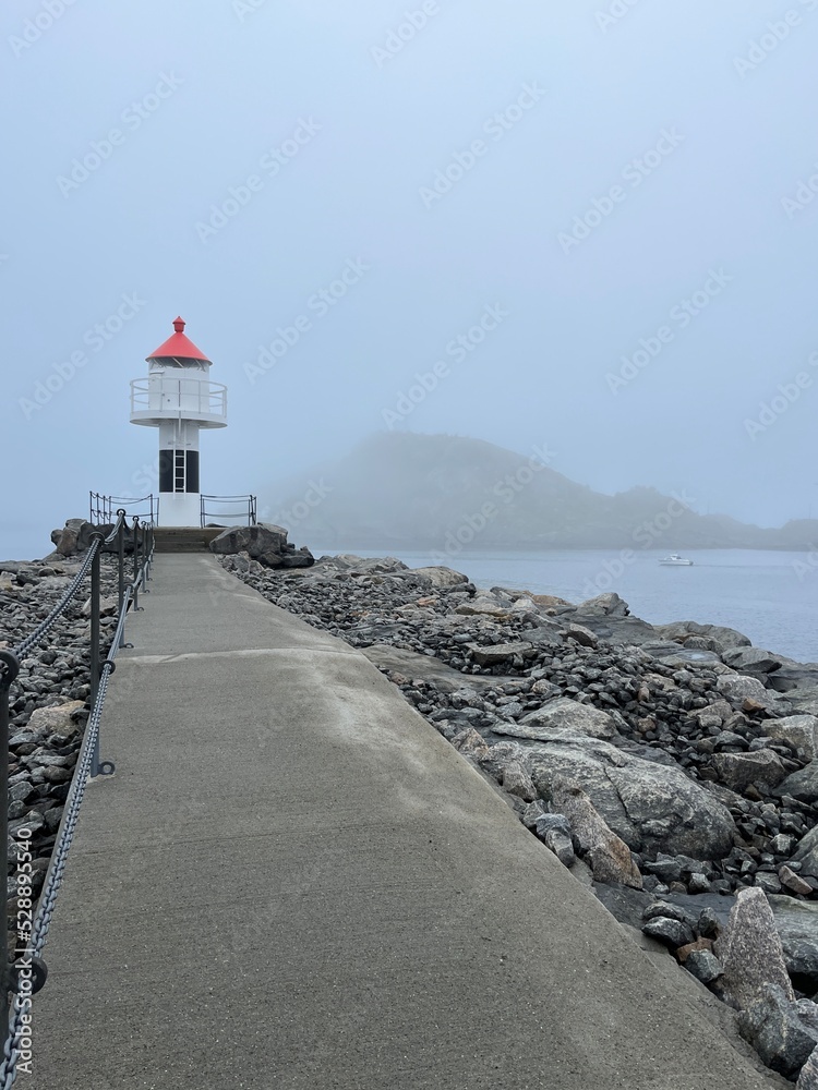 Sea lighthouse in the fog, seascape background