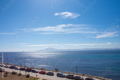 Boats in the port of Tarifa with view of the skyline of the city on the southernmost coast of the mainland, facing the Strait of Gibraltar and Morocco 