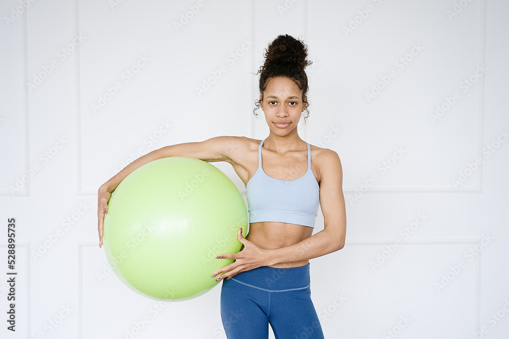 Home Sport. African american woman training on fitball in living room and enjoying fitness and healthy lifestyle Home Sport. African american woman training on fitball in living room and enjoying fitness and healthy lifestyle