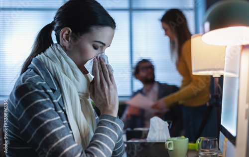 фотографія Woman working in the office and having a cold