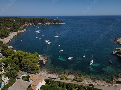 Aerial view of Cap d'Antibes and  Billionaire's Bay. Beautiful rocky beach near coastal path on the Cap d'Antibes, Antibes, France. Drone view from above of Côte d’Azur near Juan-les-Pins and Cannes. © AerialDronePics