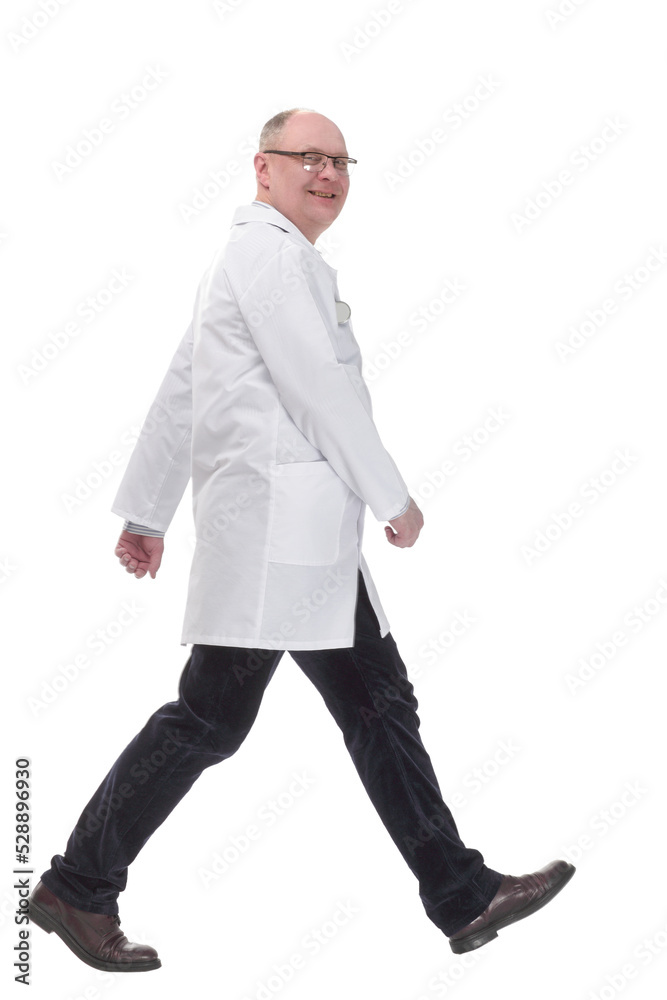 mature doctor in a white coat striding forward mature doctor in a white coat striding forward
