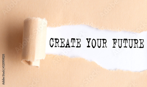 The text CREATE YOUR FUTURE appears on torn paper on white background.
