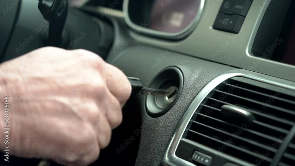 Close-up of male hand turns on and turns off the car with key. Keys, ignition . Slow motion Close-up of male hand turns on and turns off the car with key. Keys, ignition . Slow motion