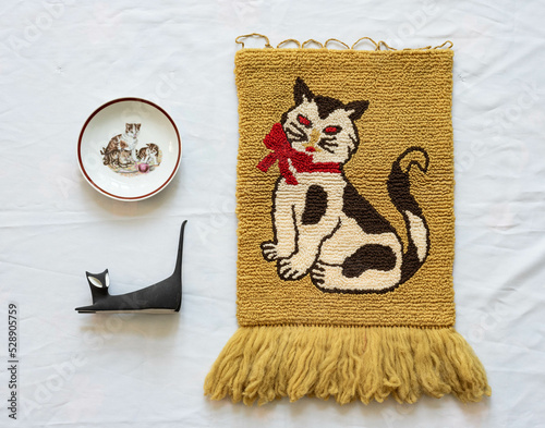 Mid-century modern carpet with a strange cat and two decorative object