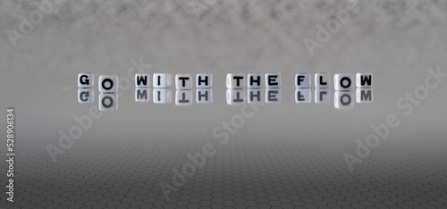 go with the flow word or concept represented by black and white letter cubes on a grey horizon background stretching to infinity