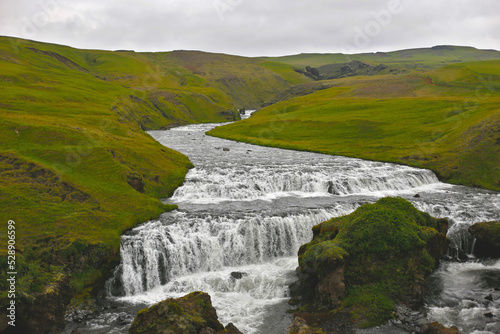 river among green meadows of iceland