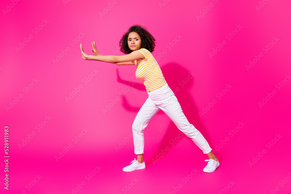 Full size photo of young attractive nice girl push hard difficult abstract empty space object serious isolated on pink color background