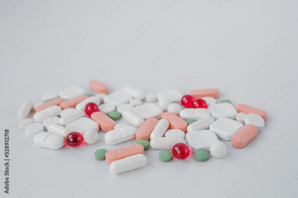 Many different pills on white background. Copy space. Top view. Concept of pharmaceuticals, medicine Many different pills on white background. Copy space. Top view. Concept of pharmaceuticals, medicine
