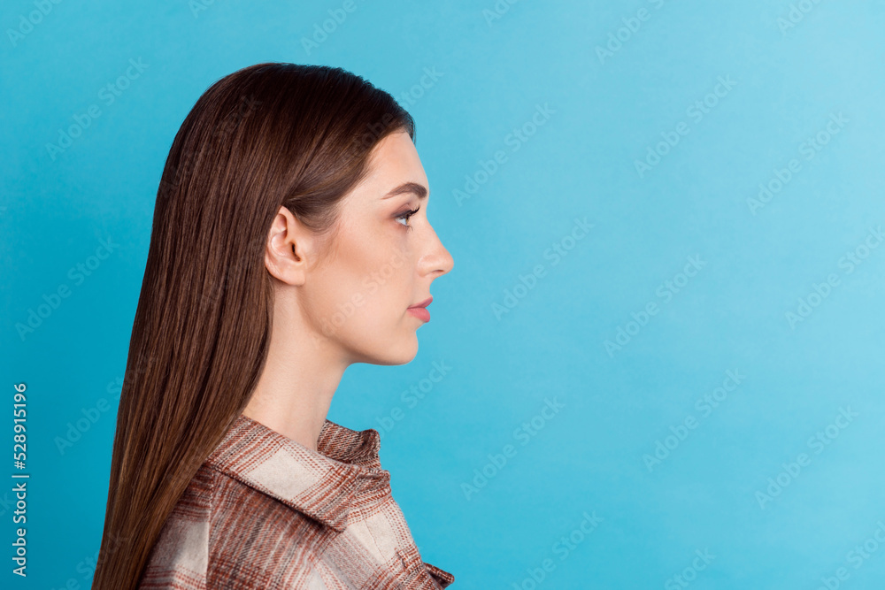 Profile photo of calm content young person look empty space ad blank isolated on blue color background Profile photo of calm content young person look empty space ad blank isolated on blue color background