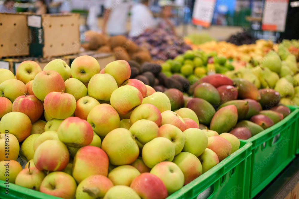 Fresh apples on the market. A lot of fruits on the supermarket counter: apples, mangoes, pears. Vitamins. Fresh apples on the market. A lot of fruits on the supermarket counter: apples, mangoes, pears. Vitamins.