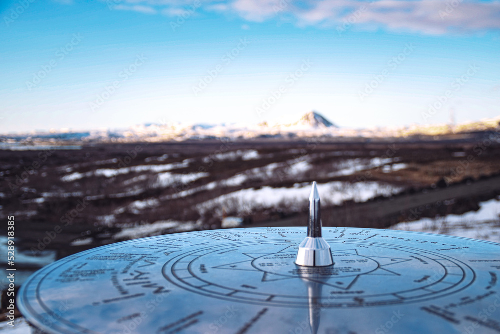 Iceland Mývatn Lake sundial close-up and snow covered mountain landscape and blue sky